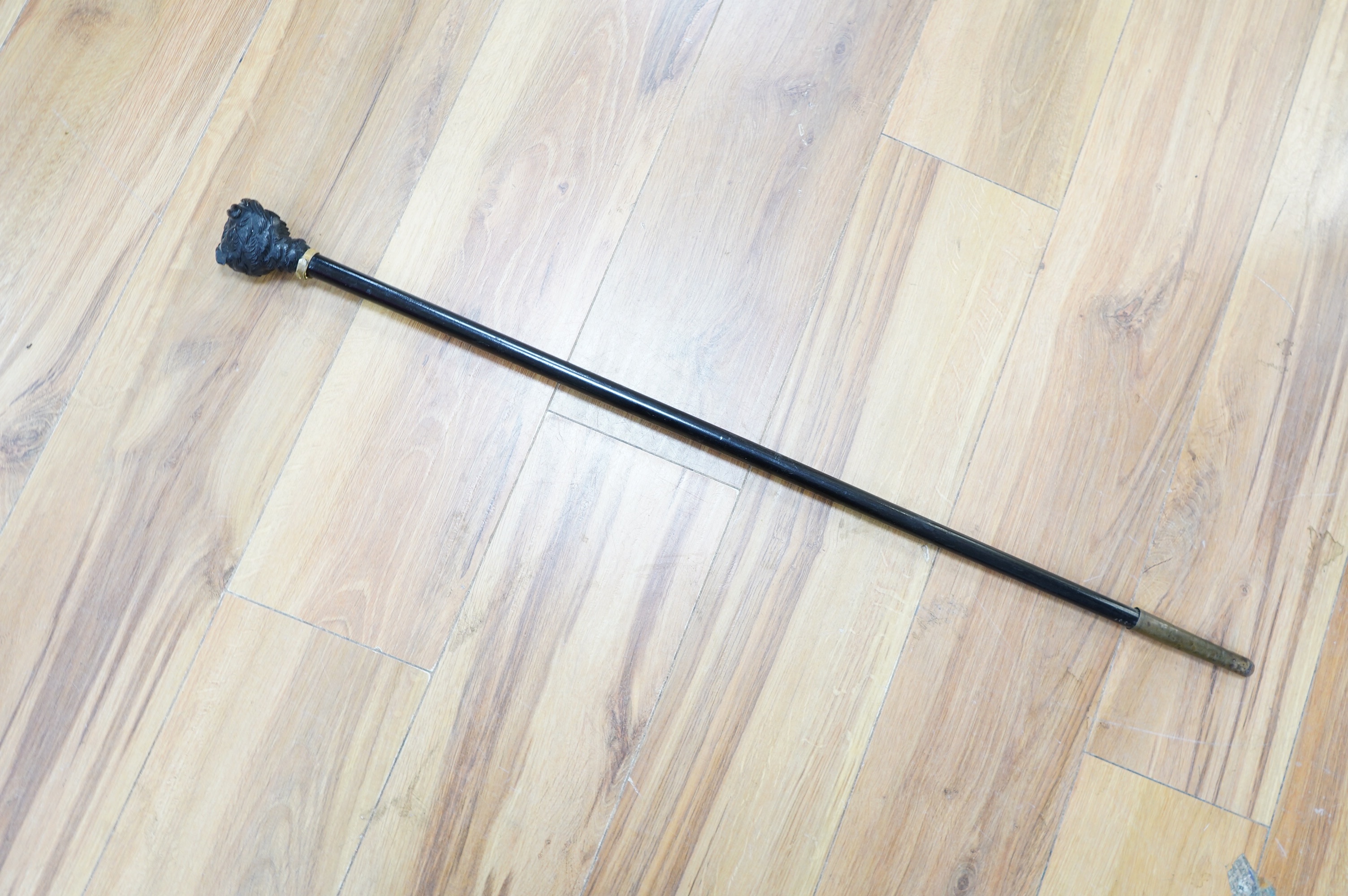 A Victorian ebony 'owl's head' walking stick, 85cm long. Condition - good.